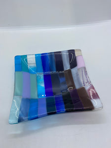Handmade fused glass patchwork dish in purples and blue glass 