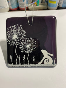 Handmade fused glass purple hanger with moon hare detail and dandelion detail 
