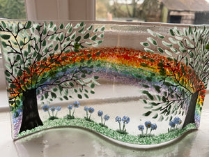 Handmade fused glass self standing rainbow with forget me knot detail 